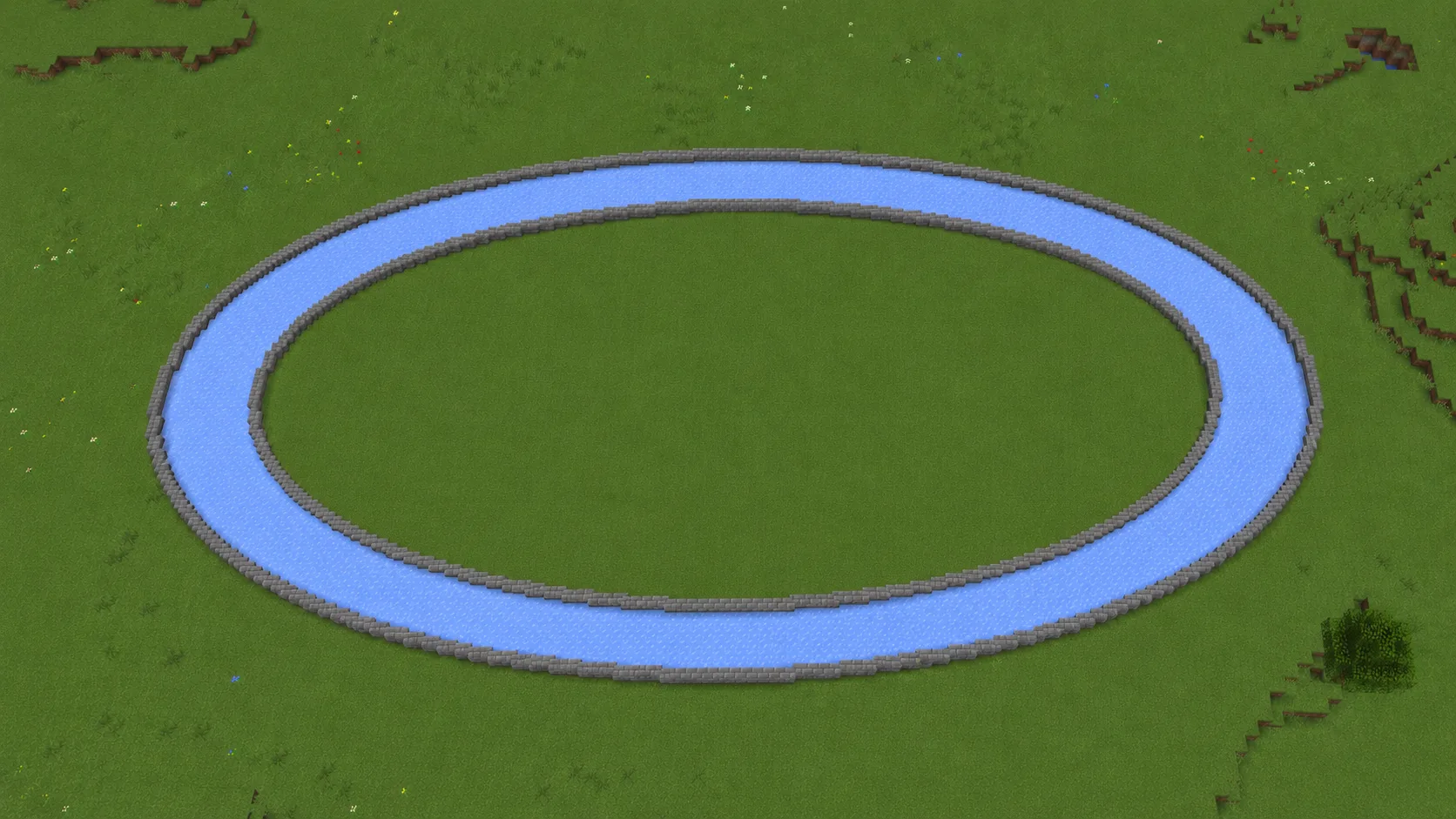 An oval Minecraft racetrack seen from above, a packed ice lane running between two stone brick walls on open grassland